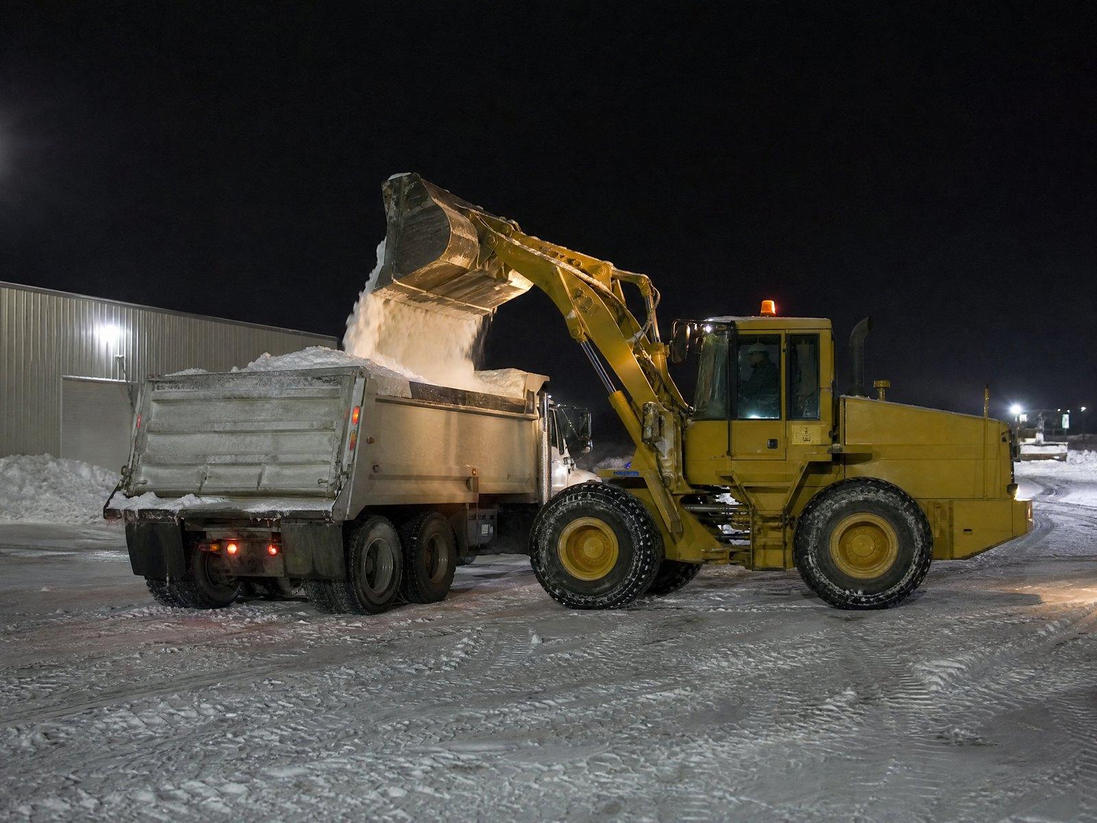 Loading snow for hauling at night